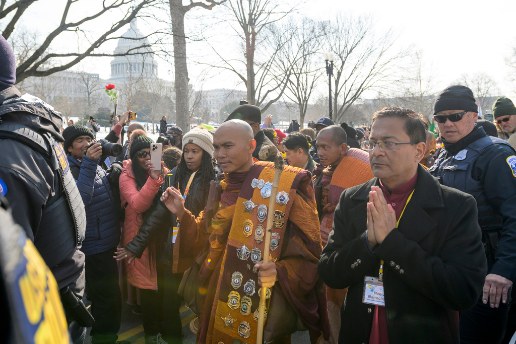 With the Capitol in the background, Bhikkhu Pannakara, center, leads his fellow Buddhist monks near the Peace Monument on Capitol Hill, during the Walk for Peace, in Washington, Wednesday, Feb., 11, 2026. (AP Photo/Rod Lamkey, Jr.)