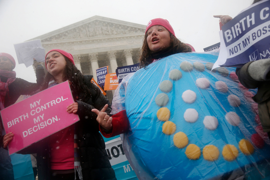 FILE - Margot Riphagen of New Orleans, La., wears a birth control pill costume during a protest in front of the U.S. Supreme Court in Washington, March 25, 2015. (AP Photo/Charles Dharapak, File)