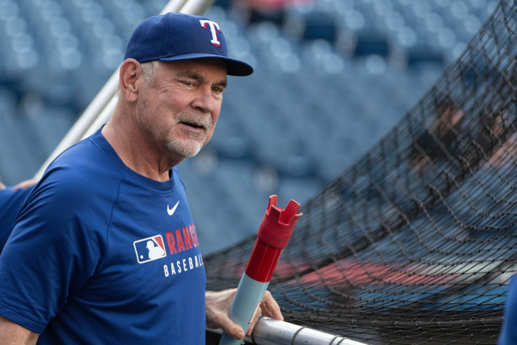 Texas Rangers manager Bruce Bochy watches his team during batting practice before the start of a baseball game against the Cleveland Guardians, Saturday, Sept. 27, 2025, in Cleveland. (AP Photo/Phil Long)