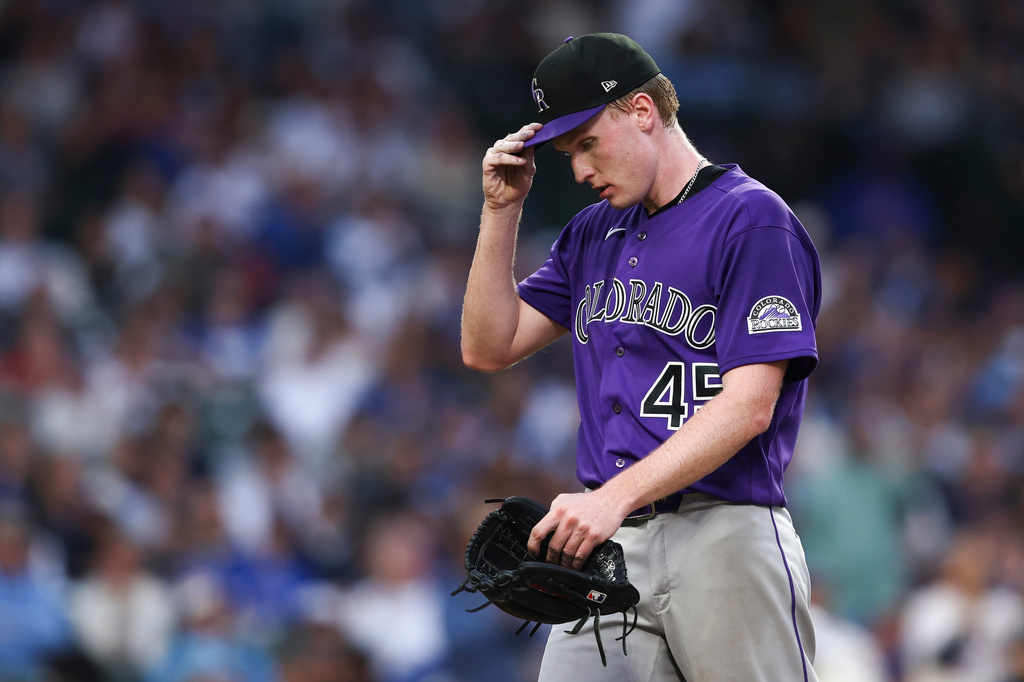 Colorado Rockies pitcher Sean Sullivan adjusts his hat while walking towards the dugout during the second inning of a baseball game against the Chicago Cubs in Chicago, Wednesday, June 17, 2026. (AP Photo/Jessie Alcheh)