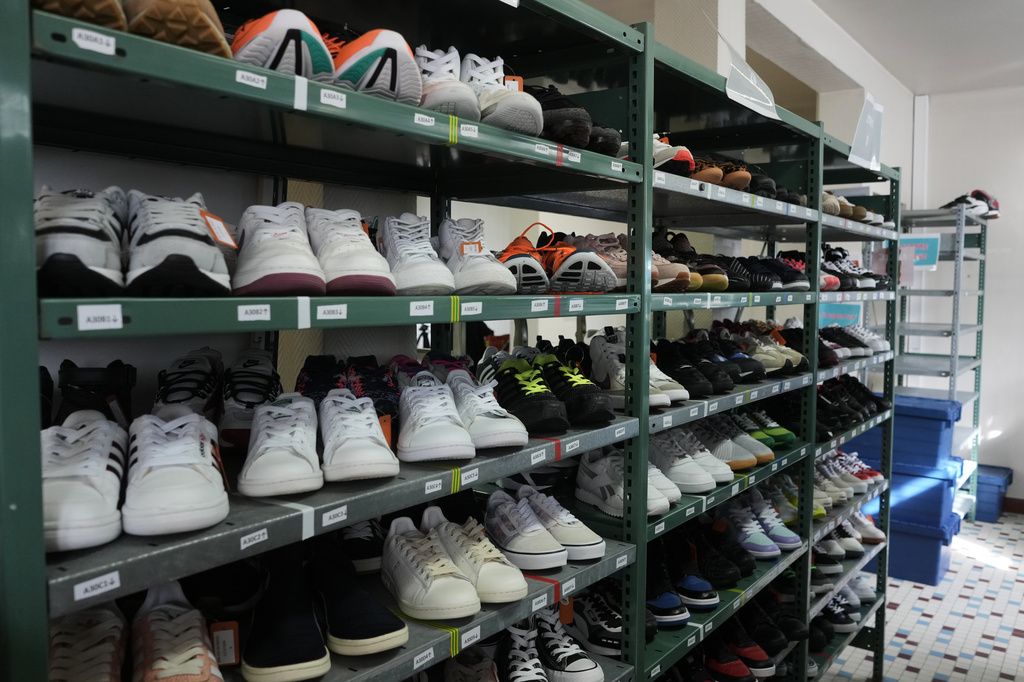 Used sneakers are stored in a room of SneakCoeurZ, a nonprofit organization giving used footwear a second life, in Champs-sur-Marne, east of Paris, Wednesday, March 25, 2026. (AP Photo/Thibault Camus)