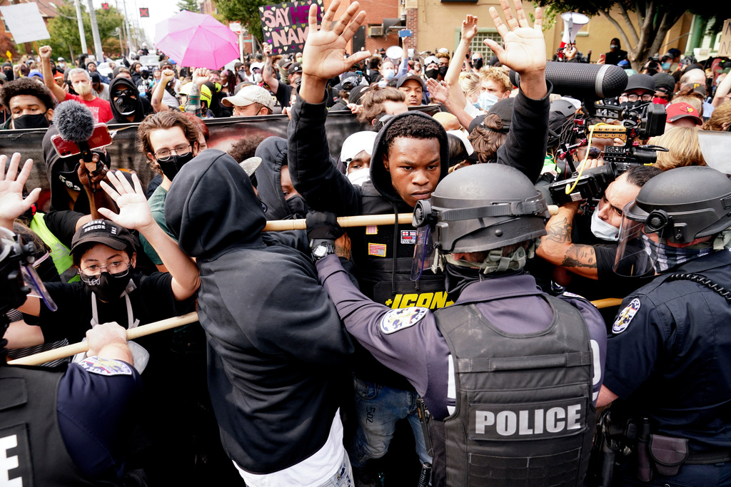 FILE - Police and protesters converge during a demonstration, Wednesday, Sept. 23, 2020, in Louisville, Ky. Recent revelations about the search warrant that led to Breonna Taylor's death have reopened old wounds in Louisville's Black community and disrupted the city's efforts to restore trust in the police department. (AP Photo/John Minchillo, File)