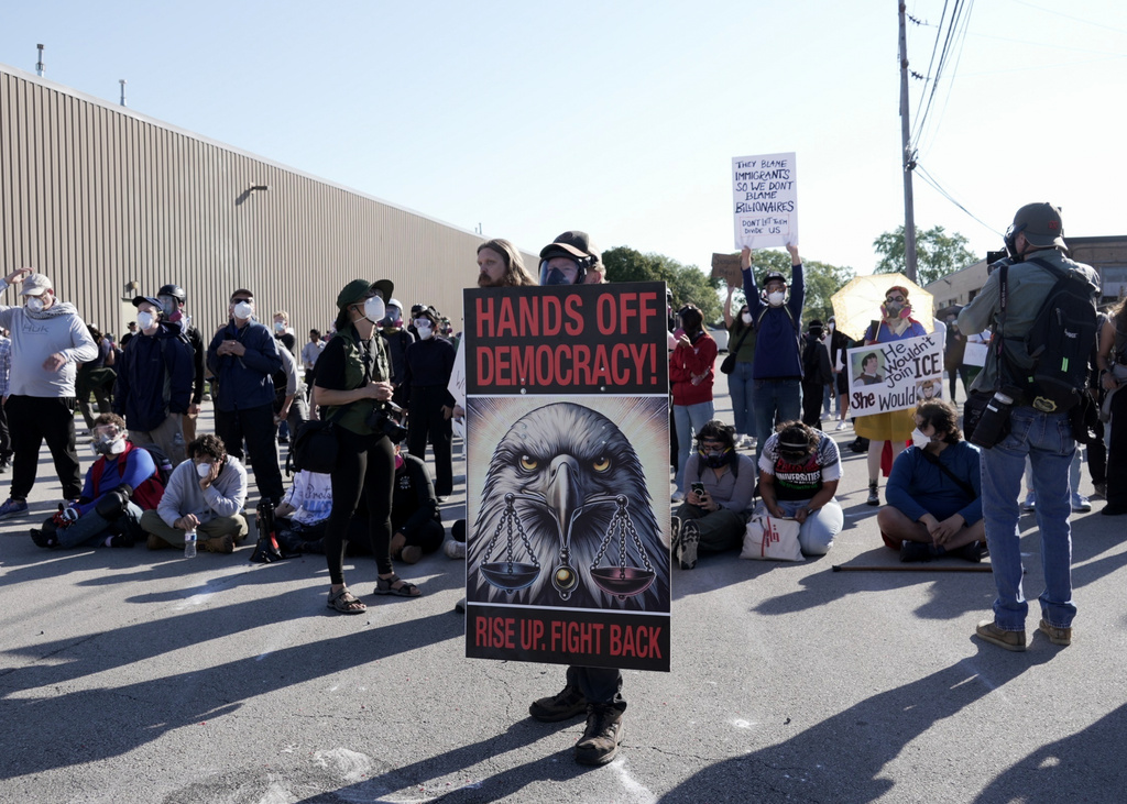 CAPTION CORRECTS LOCATION - People protest outside a federal immigration enforcement building in Broadview, Ill. on Friday, Sept. 26, 2025. (AP Photo/Laura Bargfeld)