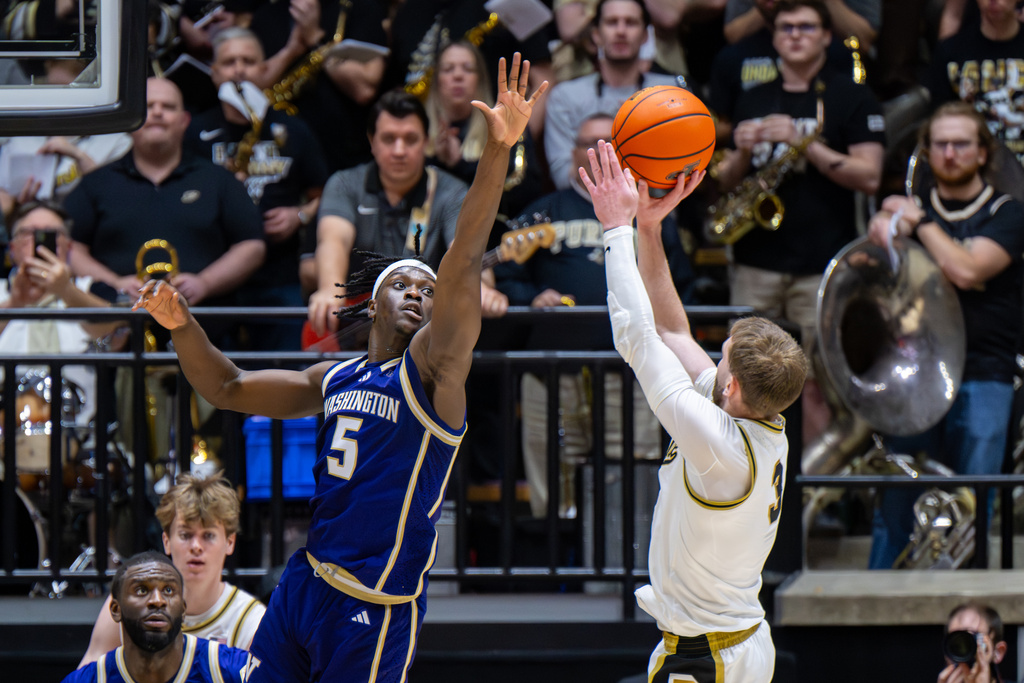 Washington guard Zoom Diallo (5) reaches out to block a shot by Purdue guard Braden Smith (3) during the first half of an NCAA college basketball game, Wednesday, Jan. 7, 2026, in West Lafayette, Ind. (AP Photo/Doug McSchooler)