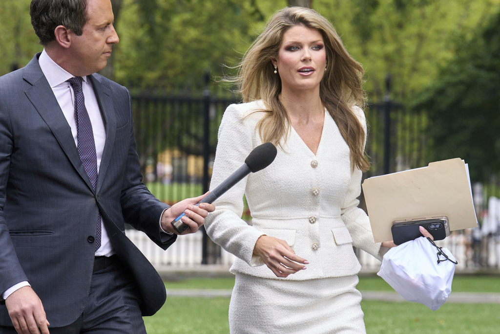 FILE - Lindsey Halligan, special assistant to the president, speaks with a reporter outside of the White House, Wednesday, Aug. 20, 2025, in Washington. (AP Photo/Jacquelyn Martin, File)