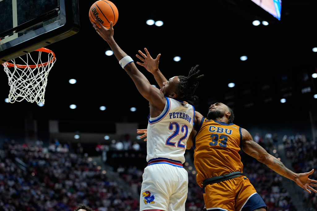 Kansas guard Darryn Peterson (22) shoots as California Baptist guard Martel Williams defends during the first half in the first round of the NCAA college basketball tournament Friday, March 20, 2026, in San Diego. (AP Photo/Mark J. Terrill)