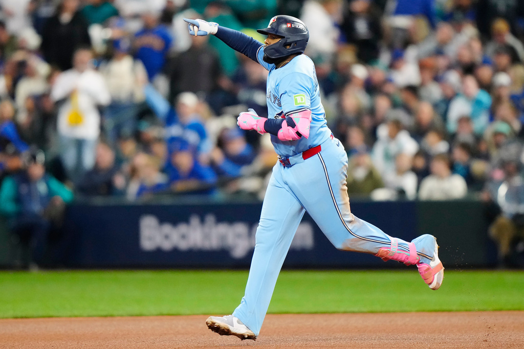 Toronto Blue Jays' Vladimir Guerrero Jr. (27) celebrates while rounding the bases after hitting a solo home run against the Seattle Mariners during fifth inning Game 3 American League Championship Series baseball action in Seattle on Wednesday, Oct. 15, 2025. (Frank Gunn/The Canadian Press via AP)