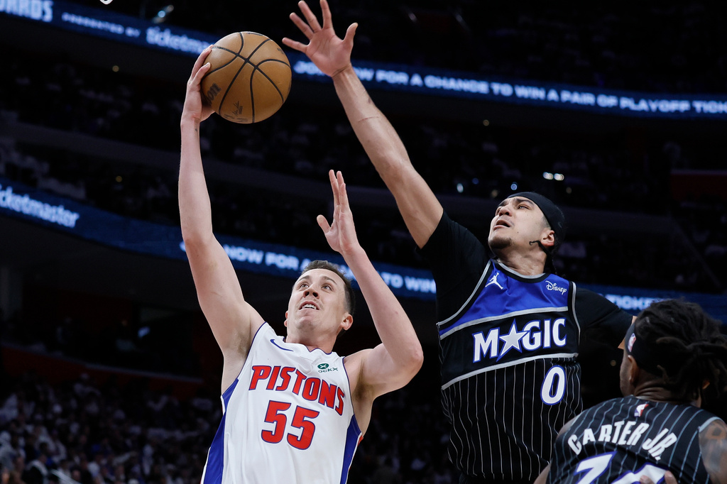Detroit Pistons forward Duncan Robinson (55) goes to the basket past Orlando Magic guard Anthony Black (0) during the first half in Game 1 of a first-round NBA basketball playoffs series Sunday, April 19, 2026, in Detroit. (AP Photo/Duane Burleson)