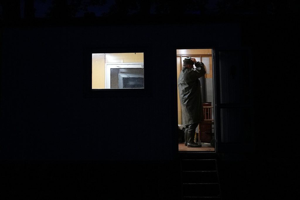 A fisherman dresses up for a traditional fish haul of the Rozmberk pond near the town of Trebon, Czech Republic, Friday, Oct. 17, 2025. (AP Photo/Petr David Josek)
