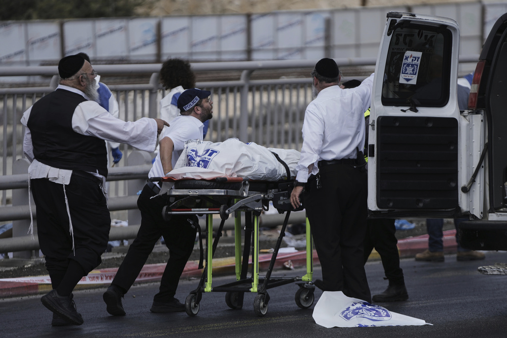 Israeli Zaka rescue and recovery team carry the body of a victim at the scene of shooting attack carried out by two Palestinian gunmen, in which several people were killed and others injured at a bus stop in Jerusalem, Monday, Sept. 8, 2025. (AP Photo/Mahmoud Illean)