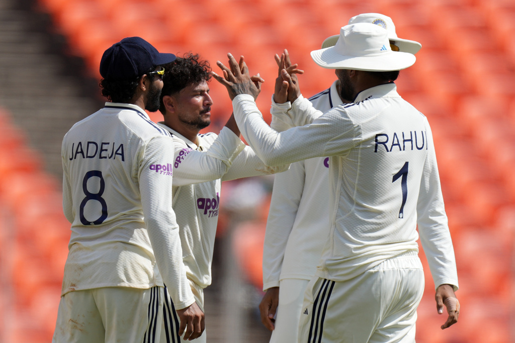 India's Kuldeep Yadav, second left, celebrates with teammates after the dismissal of West Indies' captain Roston Chase on the third day of the first Test cricket match between India and West Indies at Narendra Modi Stadium in Ahmedabad, India, Saturday, Oct. 4, 2025. (AP Photo/Ajit Solanki)