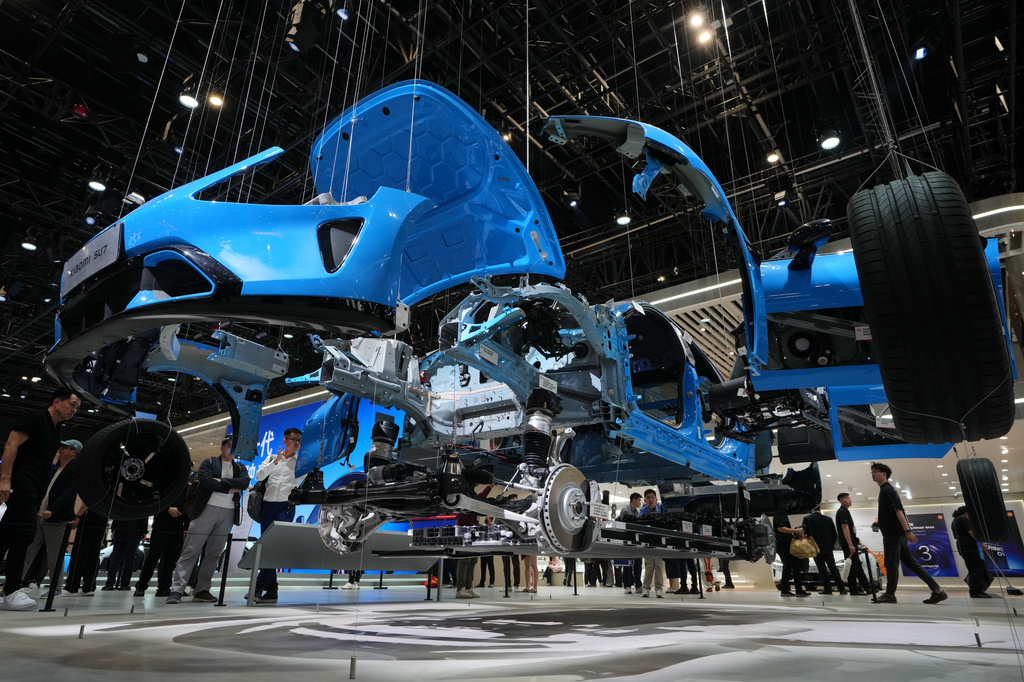 Visitors look at a SU7 model from Chinese automaker Xiaomi dismantled apart is showcased at the Auto China 2026, in Beijing, Saturday, April 25, 2026. (AP Photo/Andy Wong)