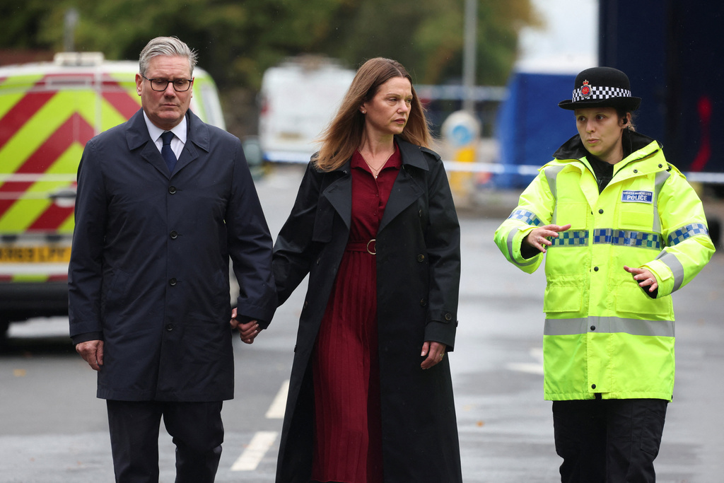Britain's Prime Minister Keir Starmer, left, and his wife Victoria Starmer visit the site of the Manchester synagogue attack, in north Manchester, England, Friday Oct. 3, 2025. (Phil Noble/Pool Photo via AP)