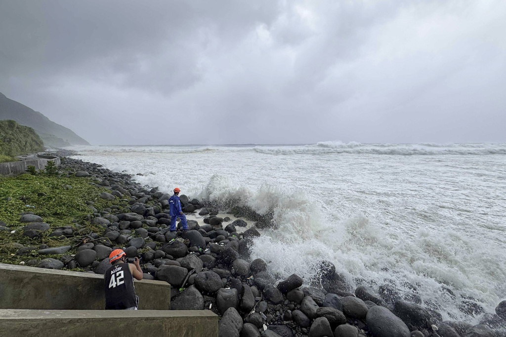 People watch as strong waves batter Basco, Batanes province, northern Philippines as Typhoon Ragasa affects the area on Monday, Sept. 22, 2025. (AP Photo/Justine Mark Pillie Fajardo)