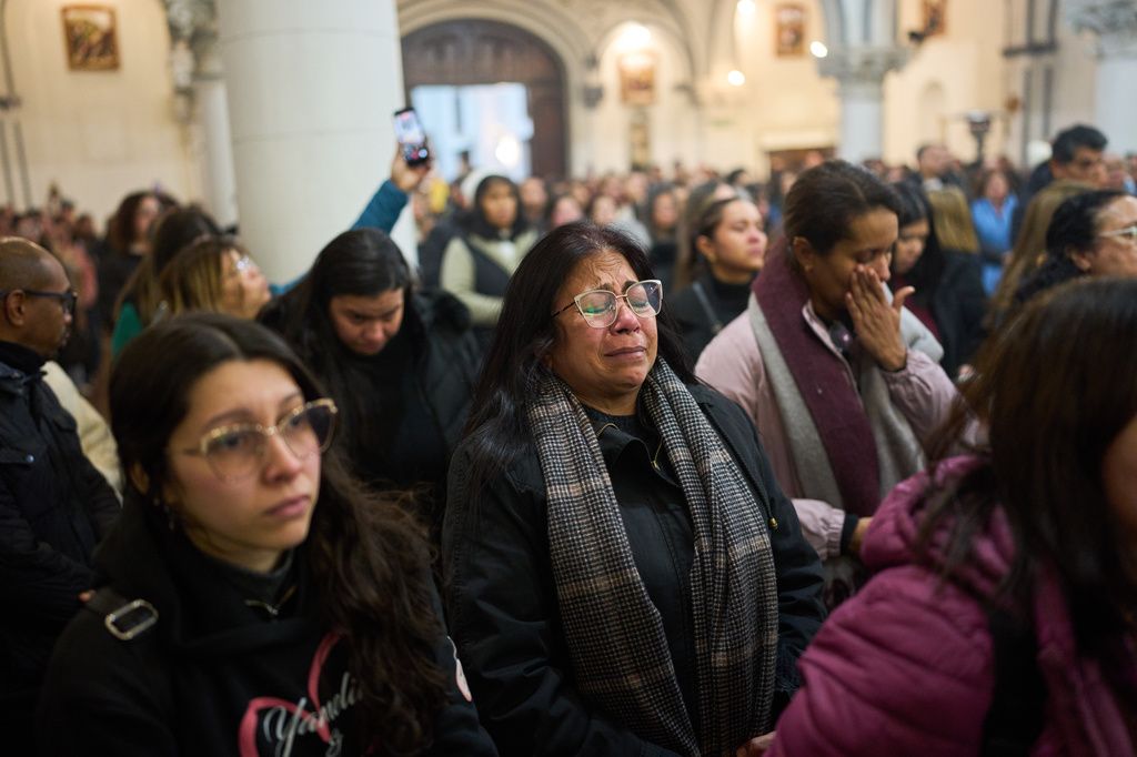 People attend a mass to honor the victims of the earthquakes in Venezuela, in Buenos Aires, Argentina, Thursday, June 25, 2026. (AP Photo/Rodrigo Abd)