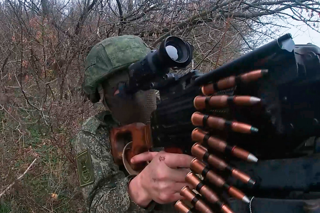 In this photo taken from a video provided by Russian Defense Ministry press service on Tuesday, Nov. 18, 2025, Russian serviceman fires in an undisclosed location in Ukraine. (Russian Defense Ministry Press Service via AP)