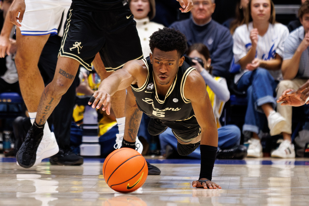 Wake Forest's Myles Colvin (6) dives for a loose ball during the first half of an NCAA college basketball game against Duke in Durham, N.C., Saturday, Jan. 24, 2026. (AP Photo/Ben McKeown)