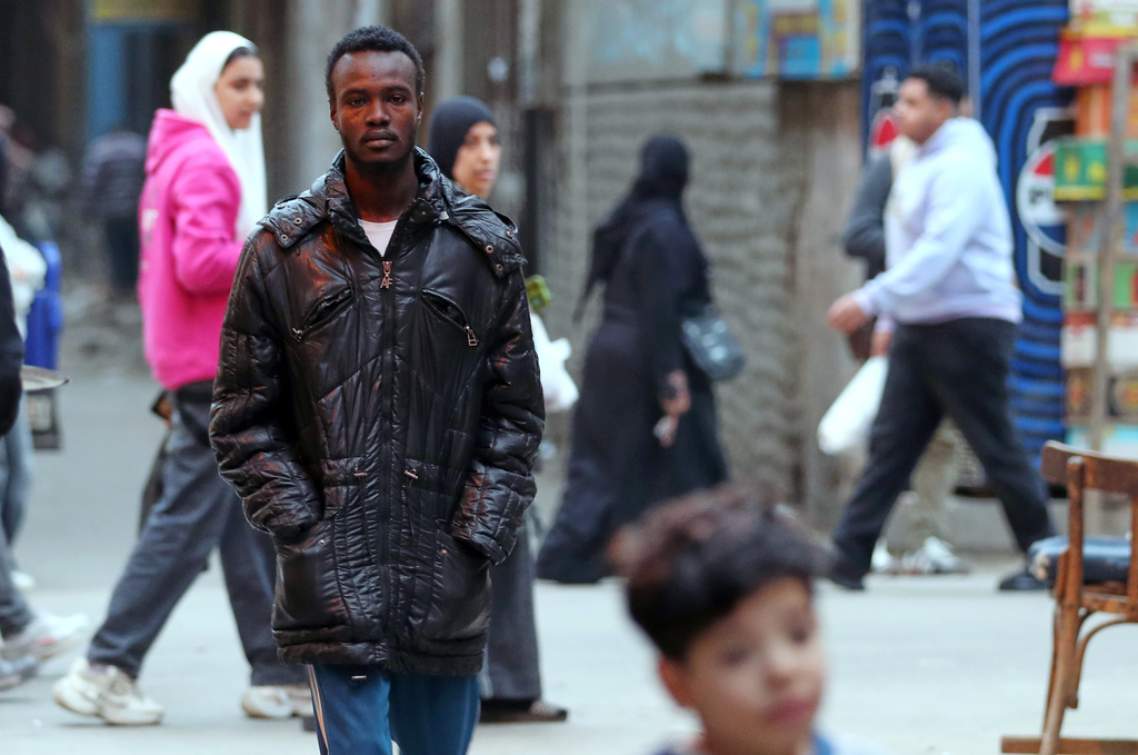 Mustafa Khater, a 28-year-old charity kitchen worker who fled with his pregnant wife a few days before el-Fasher fell to the RSF, walks at his neighborhood in Cairo, Egypt, Wednesday, Jan. 14, 2026. (AP Photo/Khaled el Fiqi)