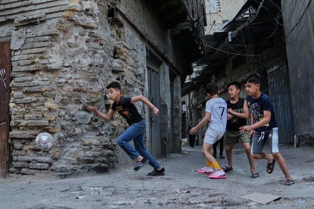 Children play soccer in the Al Fadhil neighborhood, one of the oldest neighborhoods of Baghdad, Tuesday, April 14, 2026. (AP Photo/Hadi Mizban)