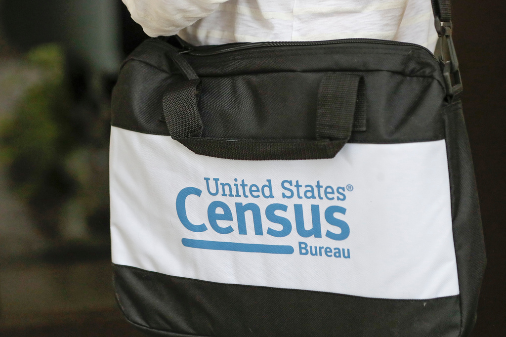 FILE - A census taker's briefcase is visible as she knocks on doors, Aug. 11, 2020, in Winter Park, Fla. (AP Photo/John Raoux, File)