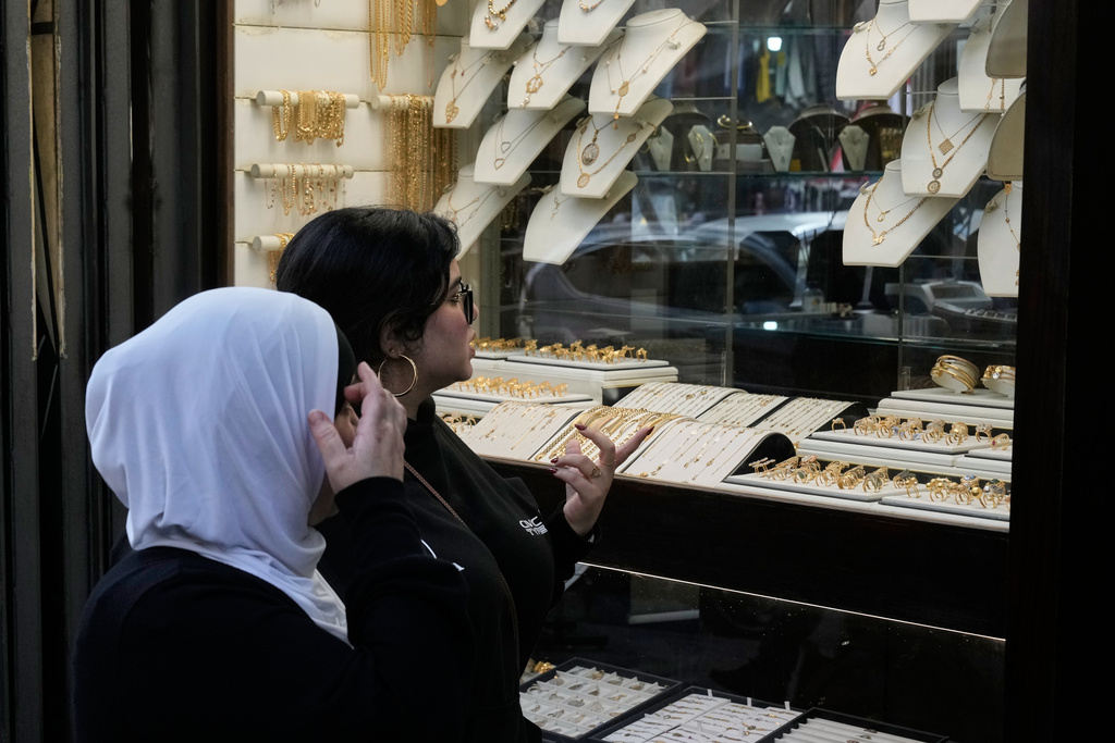 Women look at the storefront of a jewelry shop in Beirut, Lebanon, Monday, Feb. 2, 2026. (AP Photo/Bilal Hussein)