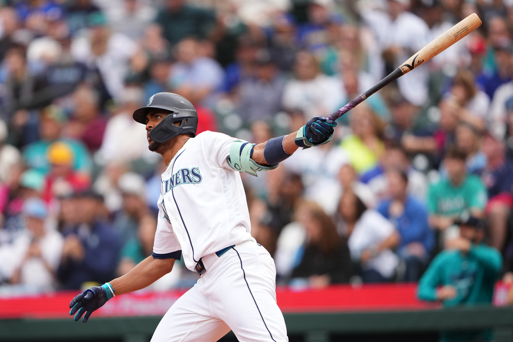 Seattle Mariners' Julio Rodríguez follows through on a three-run home run against the Texas Rangers during the seventh inning of a baseball game, Thursday, Sept. 10, 2026, in Seattle. (AP Photo/Lindsey Wasson)