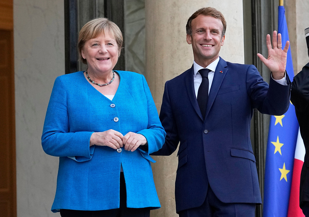 FILE - France's President Emmanuel Macron, right, welcomes German Chancellor Angela Merkel prior to a meeting at the Elysee Palace in Paris, Sept. 16, 2021. (AP Photo/Michel Euler, File)