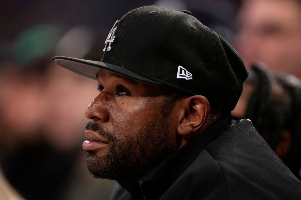 FILE - Boxer Floyd Mayweather Jr. looks on during the first half of an NBA basketball game, March 26, 2025, in New York. (AP Photo/Adam Hunger, File)