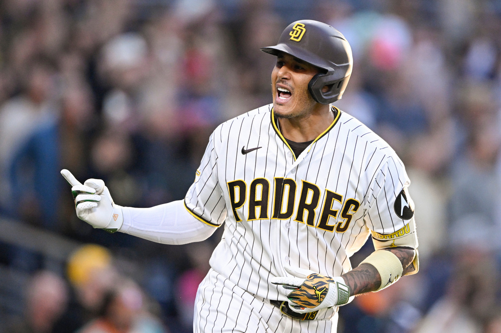 San Diego Padres' Manny Machado (13) celebrates after hitting a two-run home run during the third inning of a baseball game against the Colorado Rockies Saturday, April 11, 2026, in San Diego. (AP Photo/Denis Poroy)