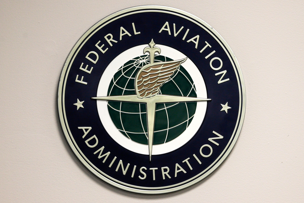 FILE - A Federal Aviation Administration sign hangs in the tower at John F. Kennedy International Airport in New York, March 16, 2017. (AP Photo/Seth Wenig, File)