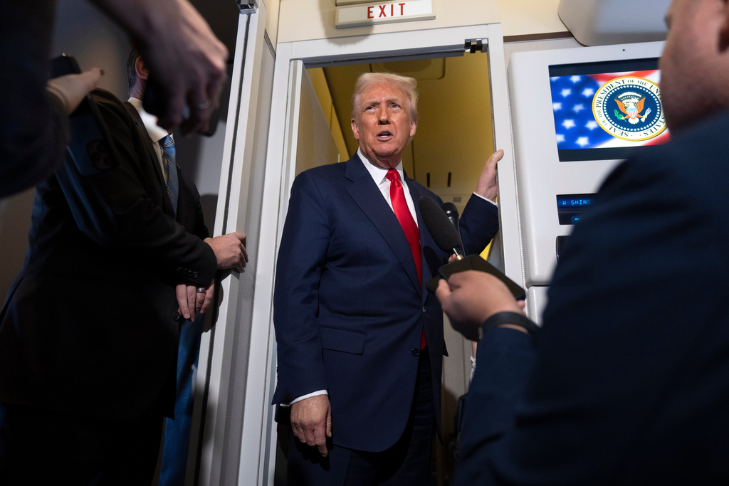 President Donald Trump speaks with reporters aboard Air Force One shortly after taking off from Busan, South Korea, en route to Joint Base Andrews, Md., Thursday, Oct. 30, 2025. (AP Photo/Mark Schiefelbein)