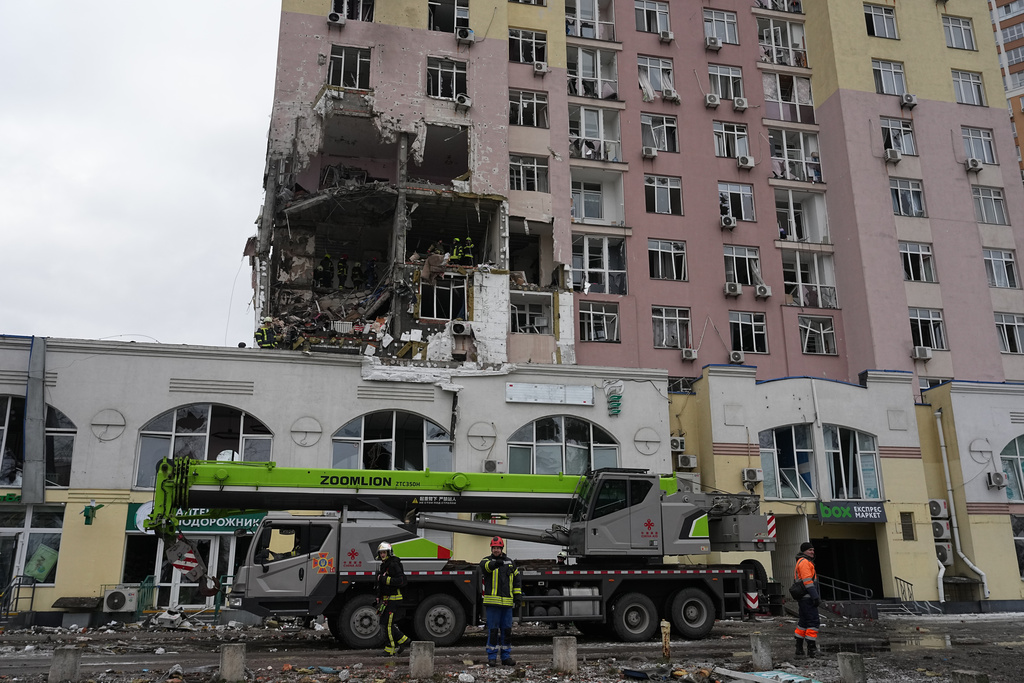 Rescuers work on the scene of a building damaged by a Russian attack in Kyiv, Ukraine, Saturday, Dec. 27, 2025. (AP Photo/Efrem Lukatsky)