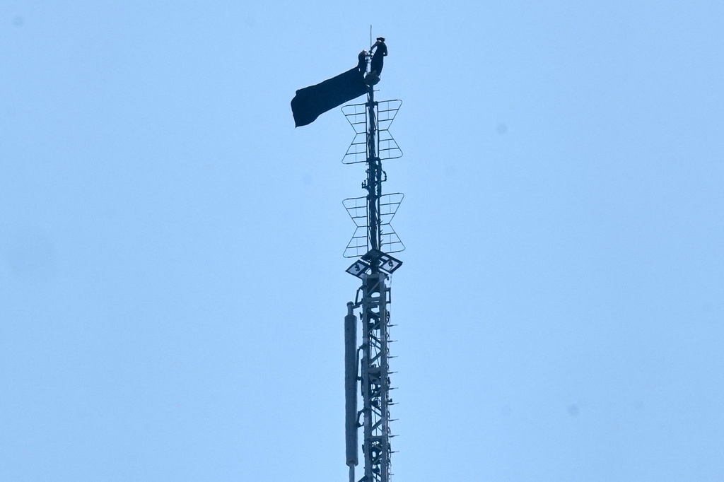A person is shown atop the spire of the Empire State Building, in New York, Wednesday, July 1, 2026. (AP Photo/Richard Drew)