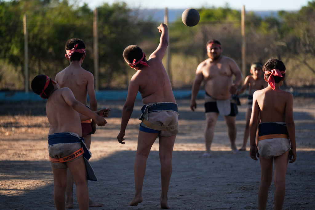 Youth play ulama, a traditional Mesoamerican ballgame dating to pre-Hispanic times, in Los Llanitos on the outskirts of Mazatlan, Mexico, Saturday, April 25, 2026. (AP Photo/Marco Ugarte)