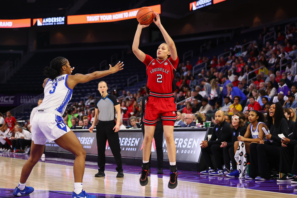 Louisville guard Imari Berry (2) shoots against Duke guard Ashlon Jackson (3) during the first half of an NCAA college basketball game in the championship of the Atlantic Coast Conference tournament, Sunday, March 8, 2026, in Duluth, Ga. (AP Photo/Colin Hubbard)