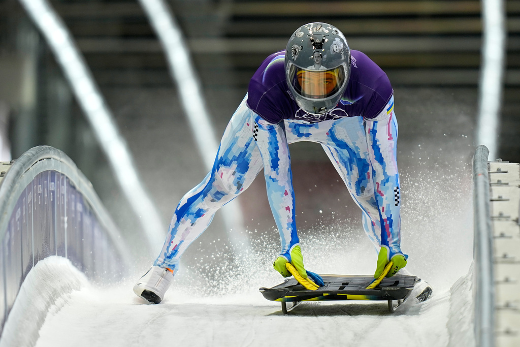 Ukraine's Vladyslav Heraskevych arrives at the finish during a men's skeleton training session at the 2026 Winter Olympics, in Cortina d'Ampezzo, Italy, Monday, Feb. 9, 2026. (AP Photo/Aijaz Rahi)