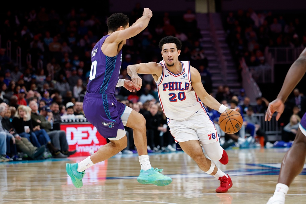 Philadelphia 76ers guard Jared McCain (20) drives against Charlotte Hornets guard Josh Green, left, during the second half of an NBA basketball game in Charlotte, N.C., Monday, Jan. 26, 2026. (AP Photo/Nell Redmond)