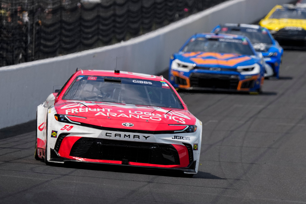 Ty Gibbs (54) heads into the first turn during a NASCAR Cup Series auto race at Indianapolis Motor Speedway in Indianapolis, Sunday, July 26, 2026. (AP Photo/Michael Conroy)