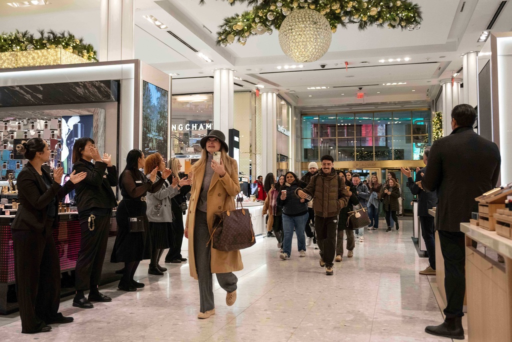 Customers walk into Macy's flagship store, Friday, Nov. 21, 2025, in New York. (AP Photo/Yuki Iwamura)