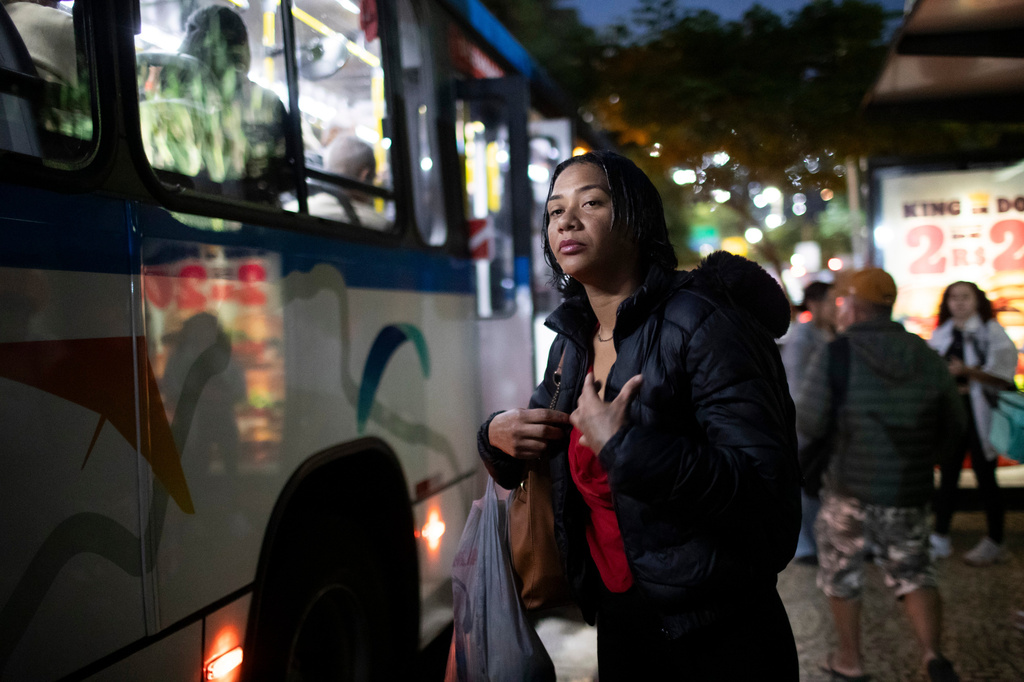 Thainara Goncalves waits for a bus to go to work at the Sao Conrado neighborhood, in Rio de Janeiro, Thursday, June 11, 2026. (AP Photo/Bruna Prado)