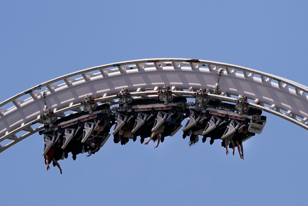 FILE - Visitors ride a roller coaster at Six Flags Magic Mountain in Valencia, Calif., April 1, 2021. (AP Photo/Jae C. Hong, File)