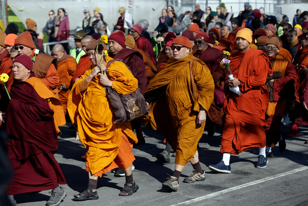 Buddhist monks walk on the National Mall during the Walk For Peace, Wednesday, Feb. 11, 2026, in Washington. (AP Photo/Rahmat Gul)