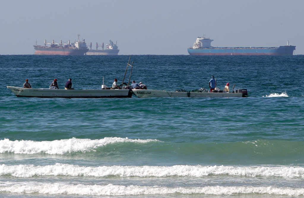 FILE - Fishermen work in front of oil tankers south of the Strait of Hormuz Jan. 19, 2012, offshore the town of Ras Al Khaimah in United Arab Emirates. (AP Photo/Kamran Jebreili, File)