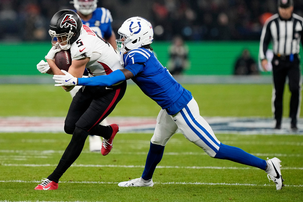 Atlanta Falcons wide receiver Drake London (5) is tackled by Indianapolis Colts cornerback Sauce Gardner (1) after catching a pass during the first half of an NFL football game, Sunday, Nov. 9, 2025, in Berlin, Germany. (AP Photo/Martin Meissner)