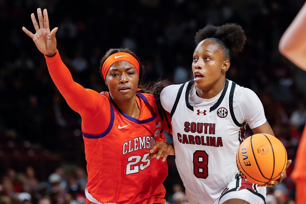 South Carolina forward Joyce Edwards (8) drives to the basket against Clemson forward Demeara Hinds during the first half of an NCAA college basketball game in Columbia, S.C., Tuesday, Nov. 11, 2025. (AP Photo/Nell Redmond)