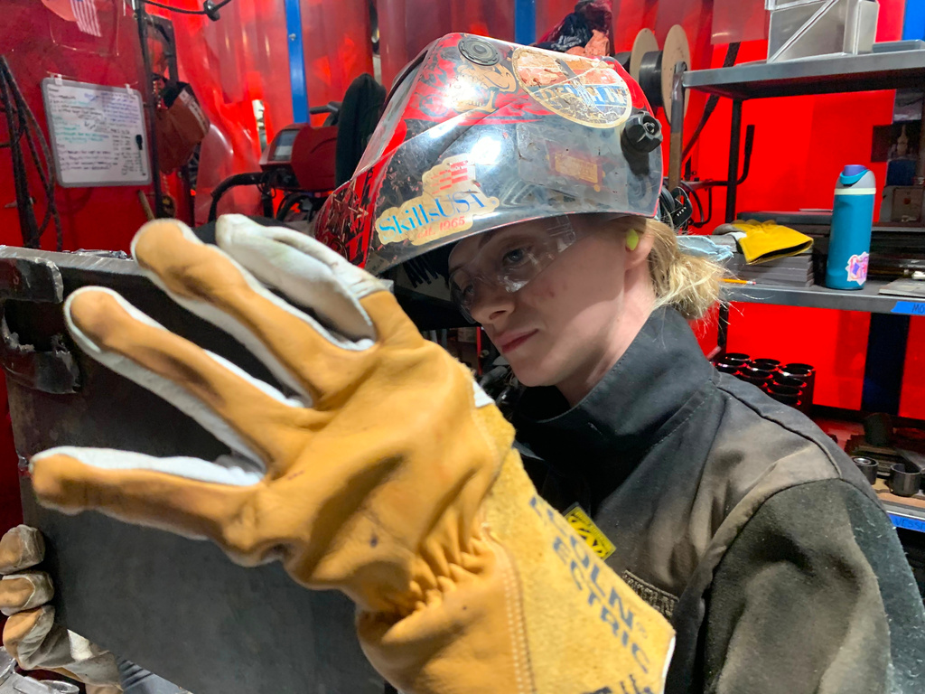 Student Mikala Sposito welds at Washtenaw Community College on Friday, May 1, 2026, in Ann Arbor., Mich. (AP Photo/Mike Householder)