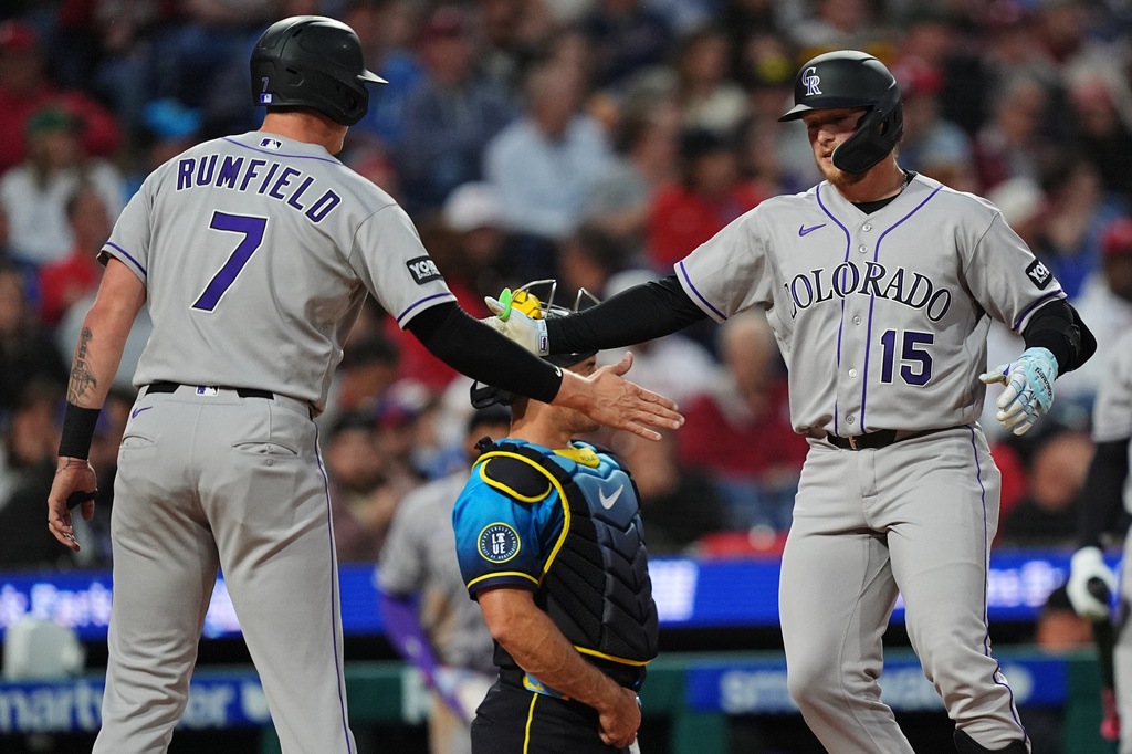 Colorado Rockies' Hunter Goodman (15) celebrates his two-run home run off of Philadelphia Phillies pitcher Jesús Luzardo, with teammate TJ Rumfield during the fourth inning of a baseball game, Friday, May 8, 2026, in Philadelphia. (AP Photo/Matt Rourke)