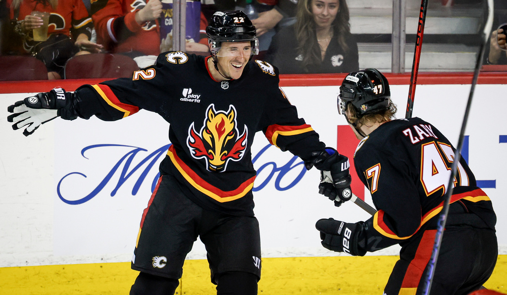 Calgary Flames' Ryan Strome, left, celebrates his goal with teammate Connor Zary during second period NHL hockey action against the Carolina Hurricanes in Calgary on Saturday, March 7, 2026. (Jeff McIntosh/The Canadian Press via AP)