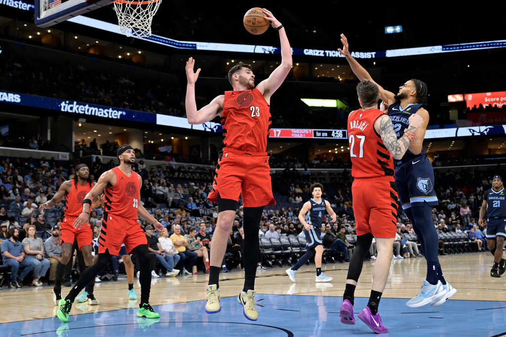 Portland Trail Blazers center Donovan Clingan (23) grabs a rebound in the first half of an NBA basketball game against the Memphis Grizzlies Wednesday, March 4, 2026, in Memphis, Tenn. (AP Photo/Brandon Dill)