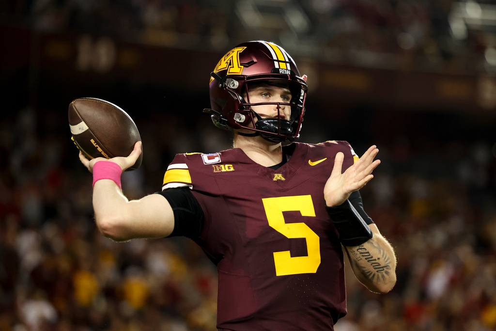 Minnesota quarterback Drake Lindsey (5) warms up on the sideline during the first half of an NCAA college football game against Nebraska, Friday, Oct. 17, 2025, in Minneapolis. (AP Photo/Ellen Schmidt)